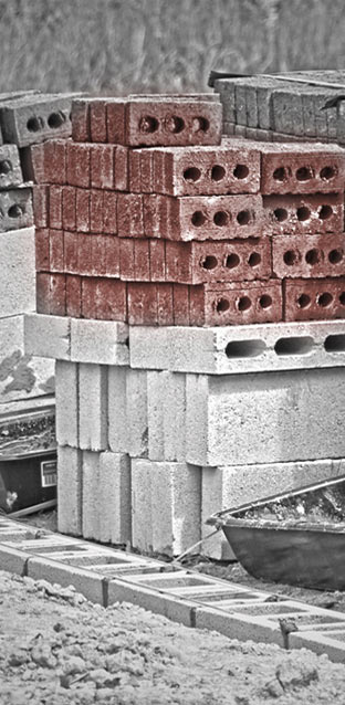 masonry bricks and blocks stacked up beside footing